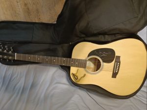 acoustic guitar with case and capo