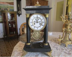 Table clock made of black marble with a semi-striking structure