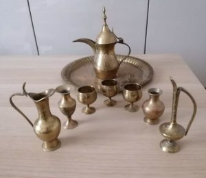 Chiseled brass spouts on a brass tray