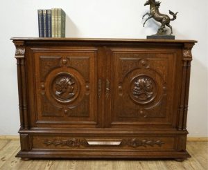 Antique carved chest of drawers with heads